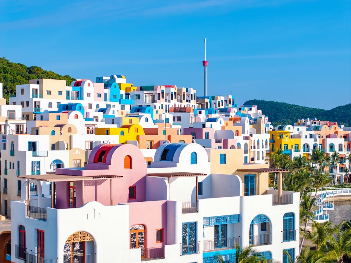 Colorful pastel buildings on a hillside under a clear blue sky